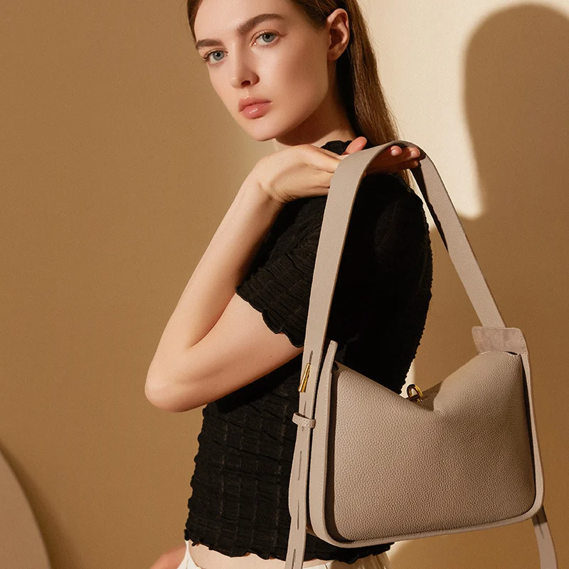 Sac fourre-tout pour femme en cuir gris porté à l'épaule
